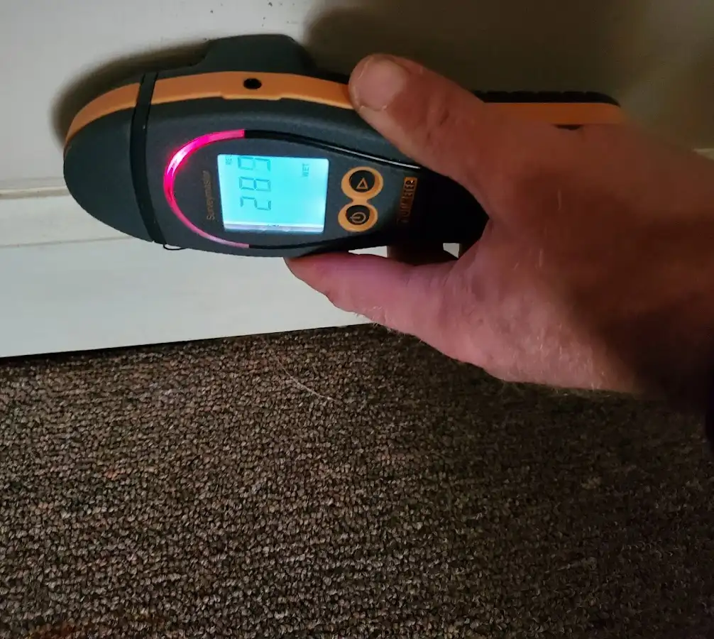 Moisture detection at baseboard during Storm Damage Restoration in St. Anthony